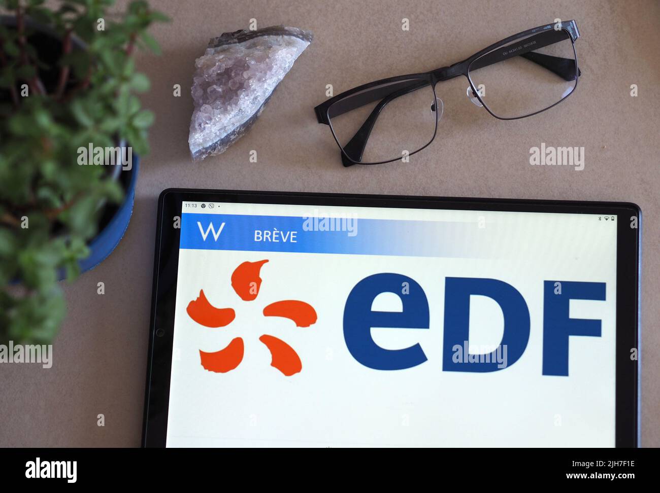 In this photo illustration, Electricite de France S.A. (EDF) logo seen displayed on a tablet. Stock Photo