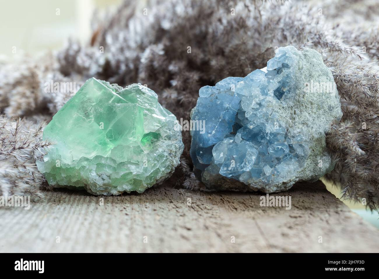 Green Fluorite and Blue Celestine Stone minerals gemstone close up on wooden background. Natural healing gems for collection or spiritual therapy. Stock Photo