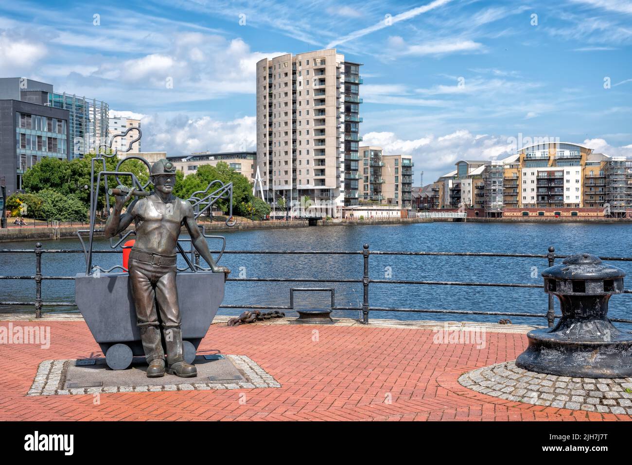 Statue of Welsh Miner entitled From Pit To Port by Roath Basin in the Cardiff Bay area of Cardiff, Wales, United Kingdom Stock Photo