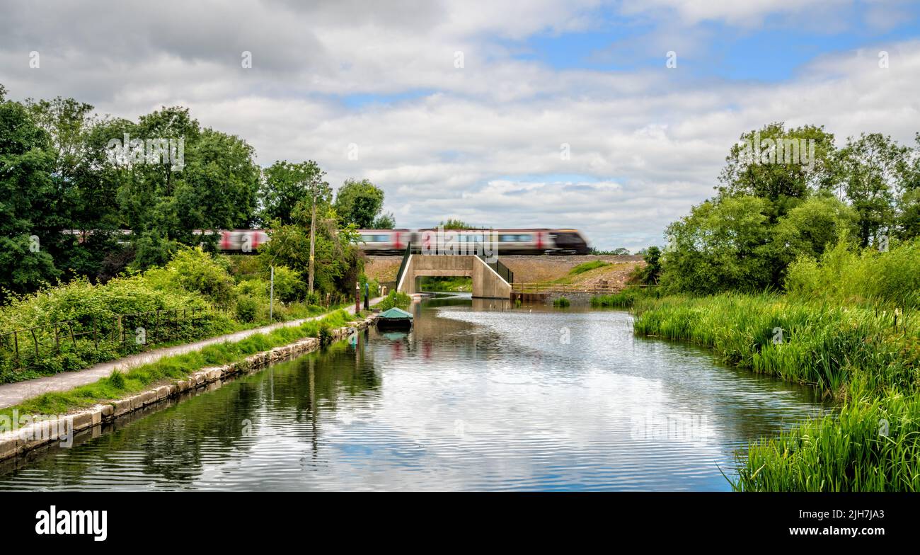 Train crossing the new railway bridge at Ocean on the Stroudwater canal, Stonehouse, Stroud, United Kingdom Stock Photo