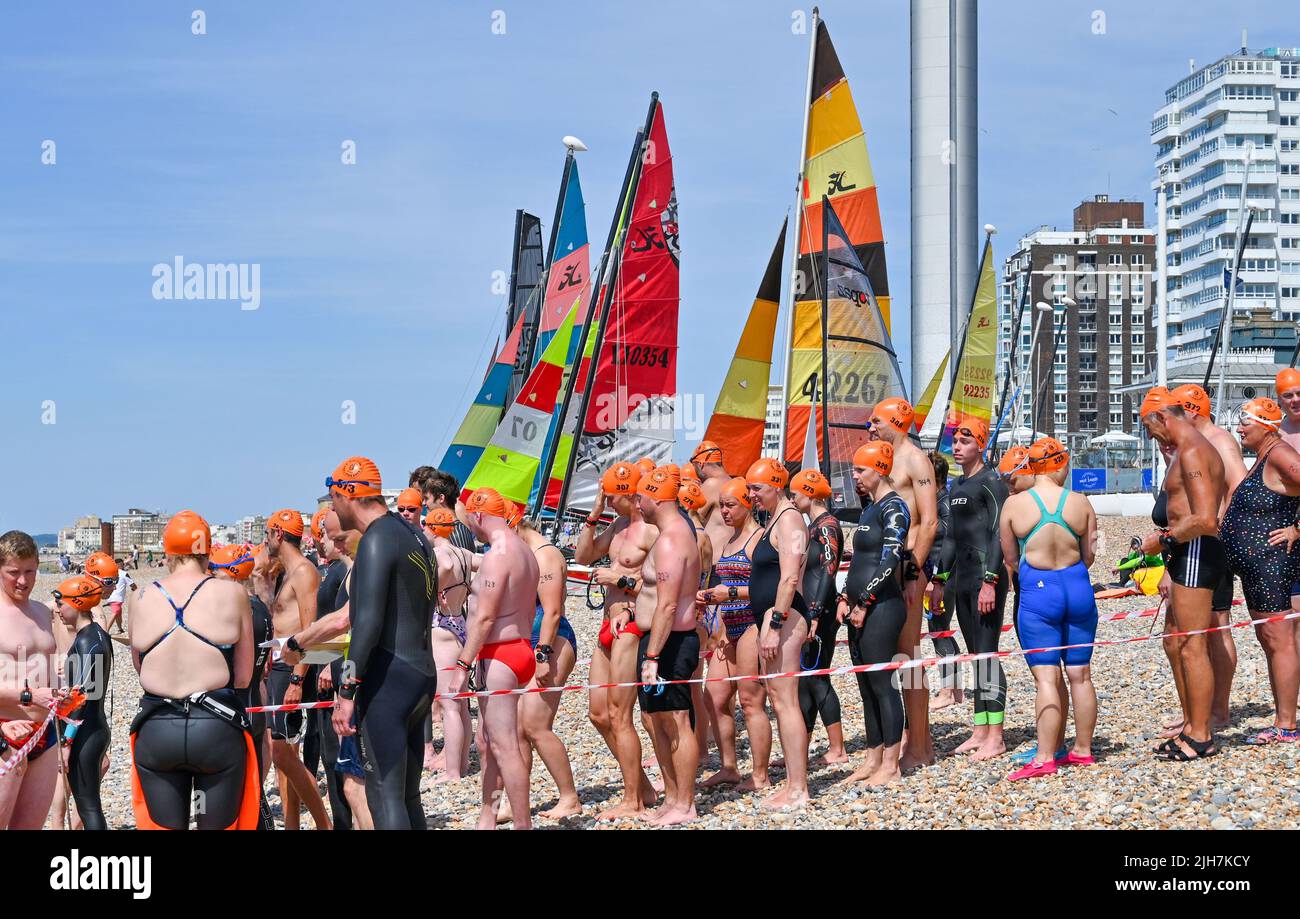 Brighton UK 16th July 2022 - Swimmers ready for the start of the Brighton Pier to Pier race on a hot sunny day . A red extreme weather warning has been issued for the beginning of next week as temperatures are expected to reach 40 degrees in some parts of Britain .  : Credit Simon Dack / Alamy Live News Stock Photo