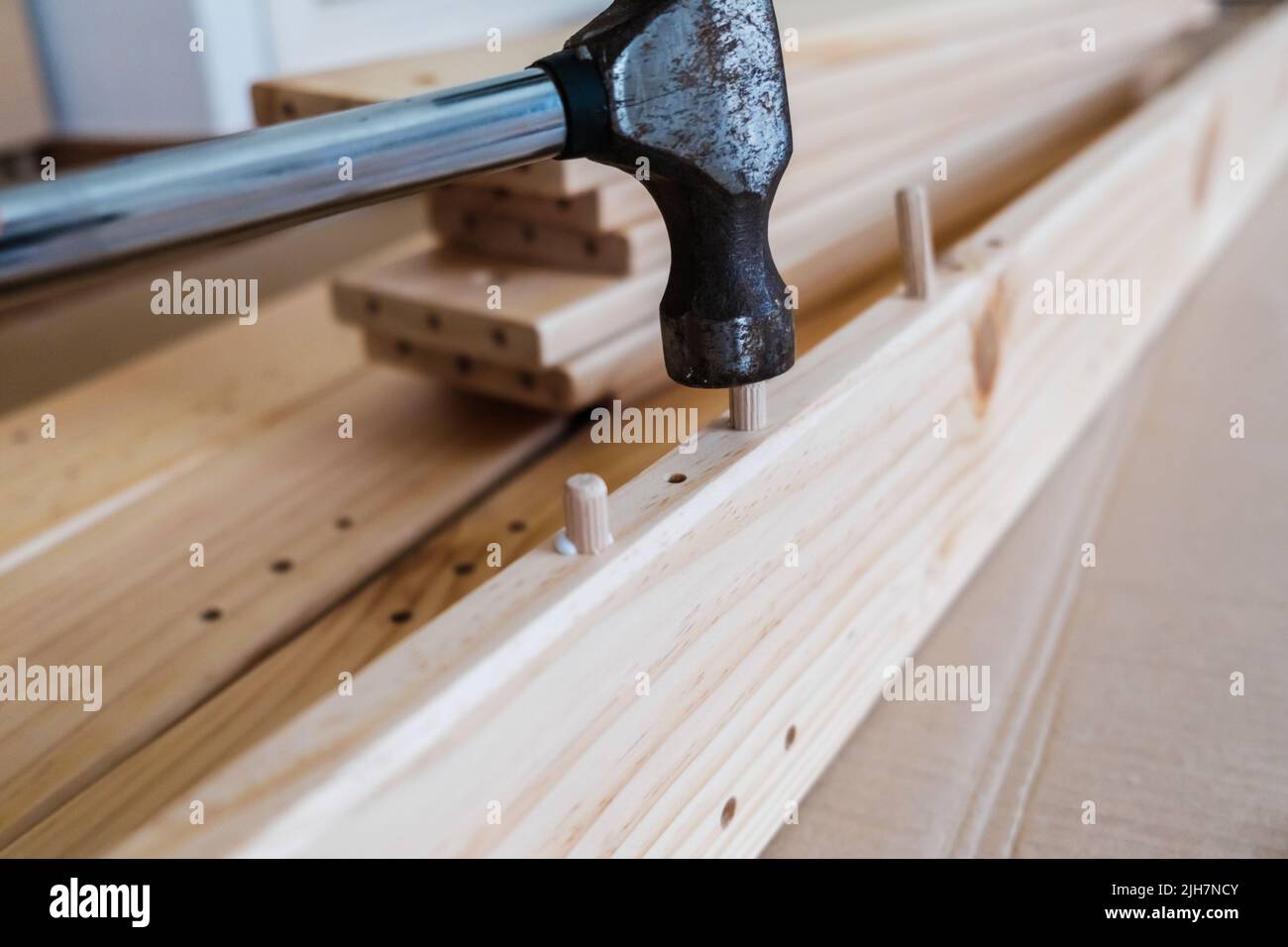 Wooden boards with wooden nails to join a piece of furniture with a ...