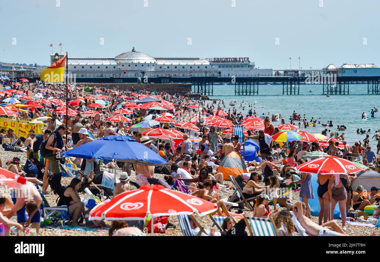 Brighton UK 16th July 2022 - Brighton beach is packed as crowds enjoy the hot sunshine today but an extreme red weather warning has been issued for the early part of next week : Credit Simon Dack / Alamy Live News Stock Photo