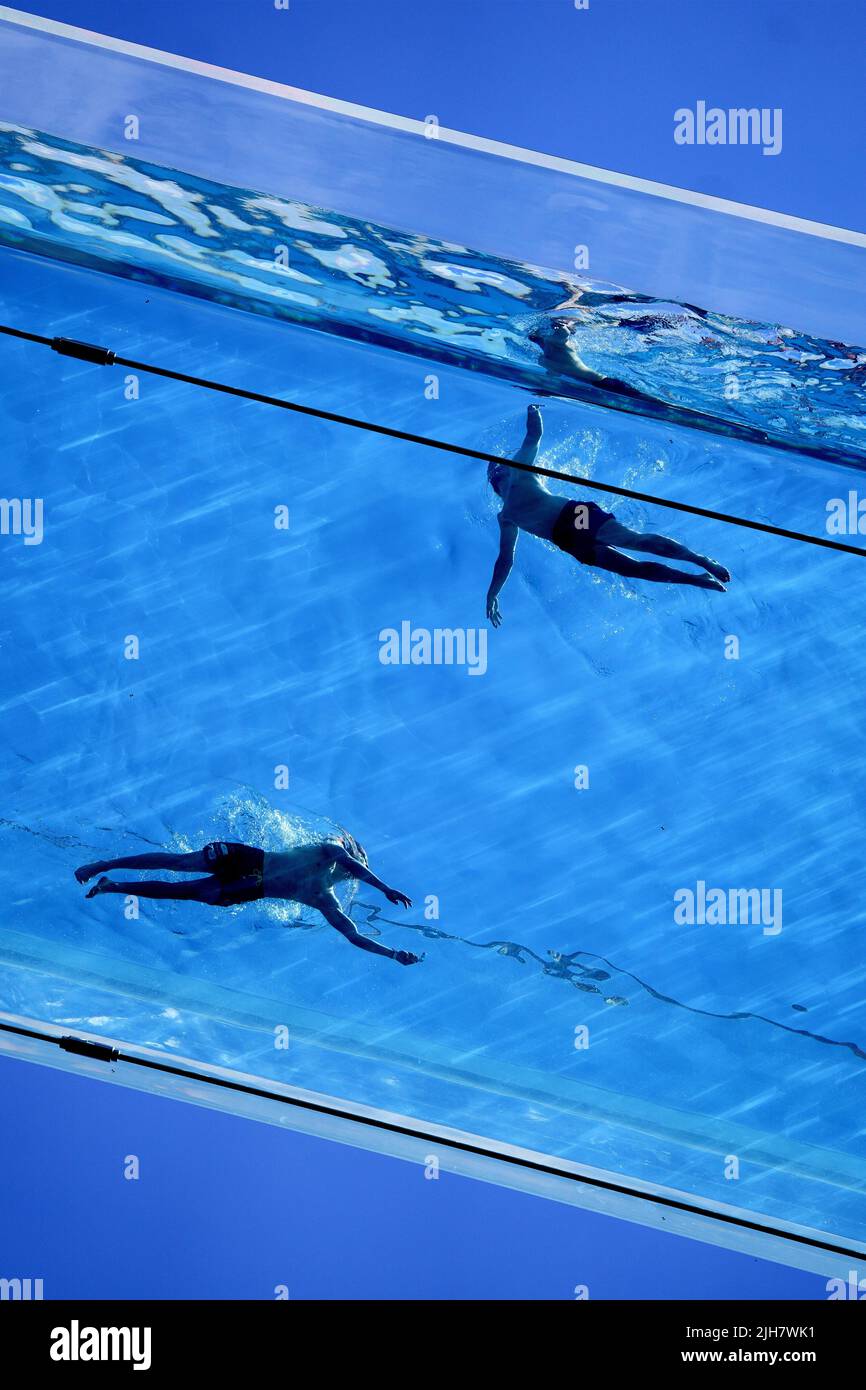 Swimmers in the Sky Pool, a transparent swimming pool suspended 35 ...
