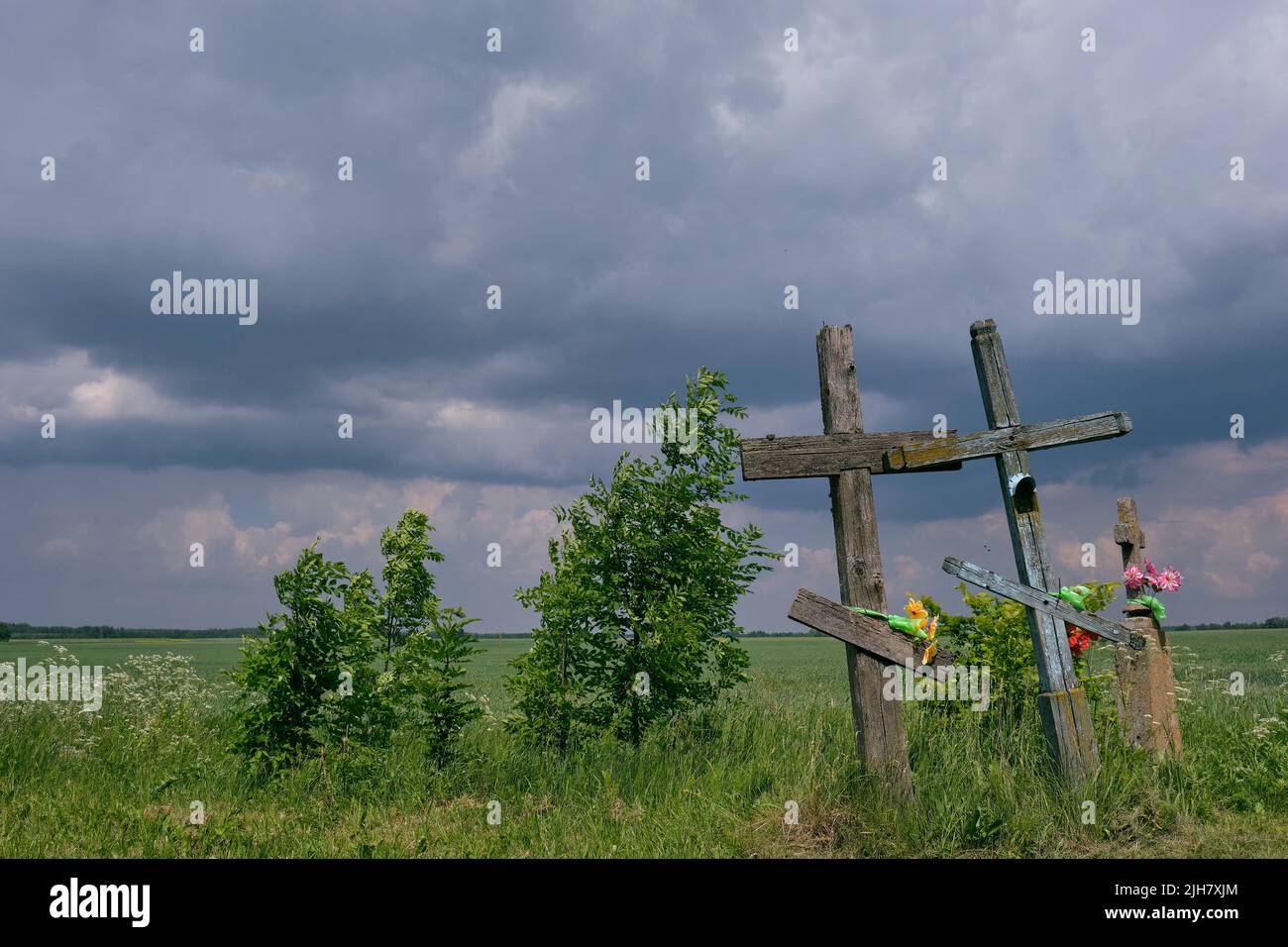 Next to road crosses and cloudy blue sky in early summer,Podlasie Region,Poland,Europe Stock Photo