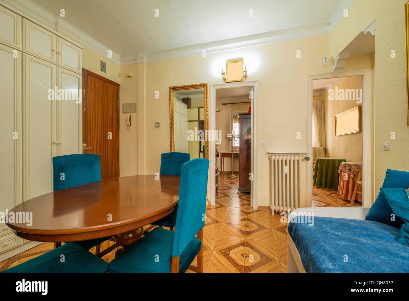 Living room of a house with a wooden dining table with blue