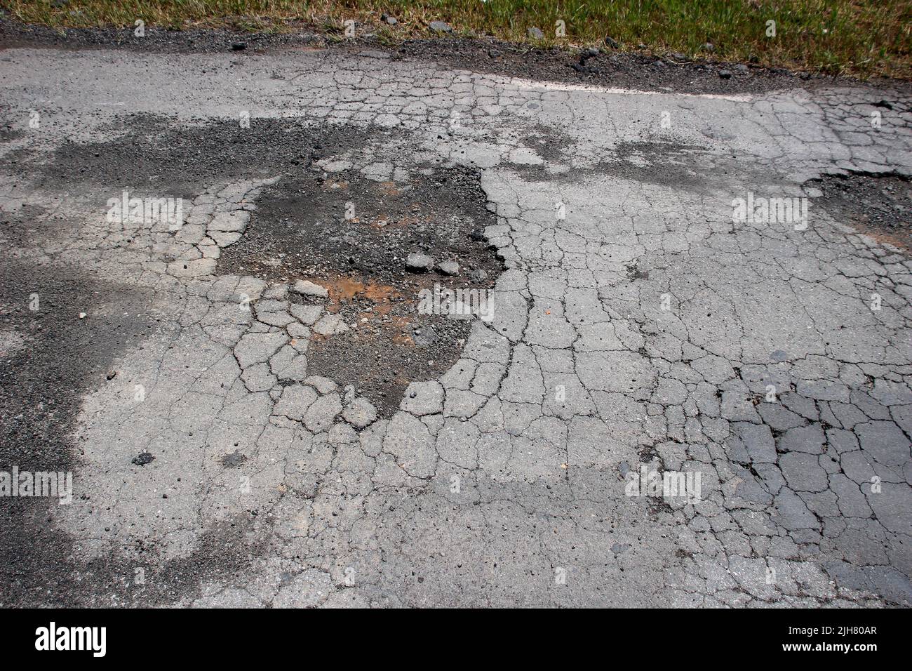 highway roof with defective and spoiled asphalt, dangerous for traffic Stock Photo