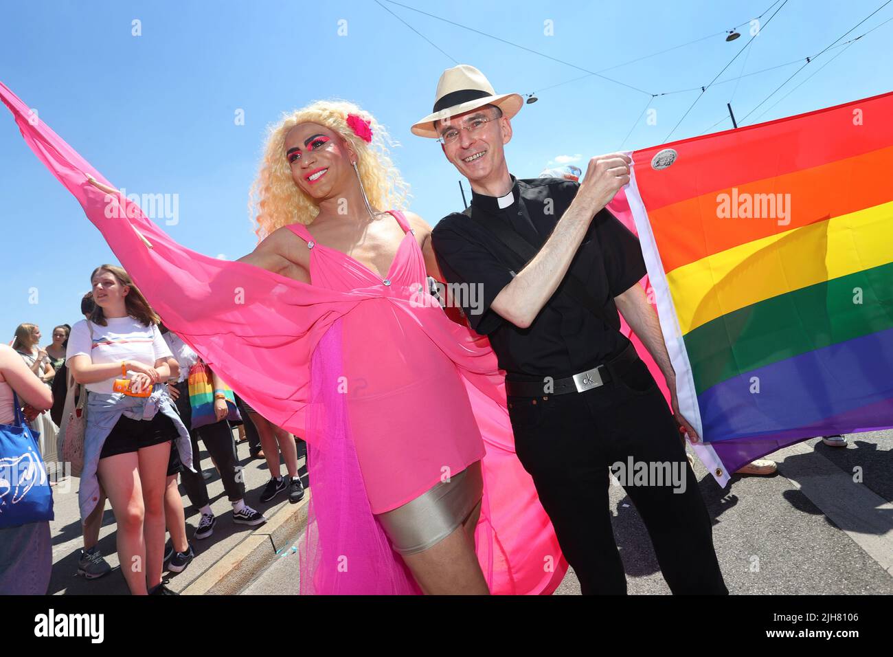 Munich, Germany. 16th July, 2022. Wolfgang Rothe, Catholic priest (r), takes part in the Christopher Street Day (CSD) parade in the city center. Catholic priest Wolfgang Rothe wants to set an example with an appearance at this year's CSD parade in Munich. The CSD motto is 'Less me, more we.' The CSD is intended to remind people of the rights of lesbians, gays, bisexuals, transgender, intersex and queer people. Credit: Karl-Josef Hildenbrand/dpa/Alamy Live News Stock Photo