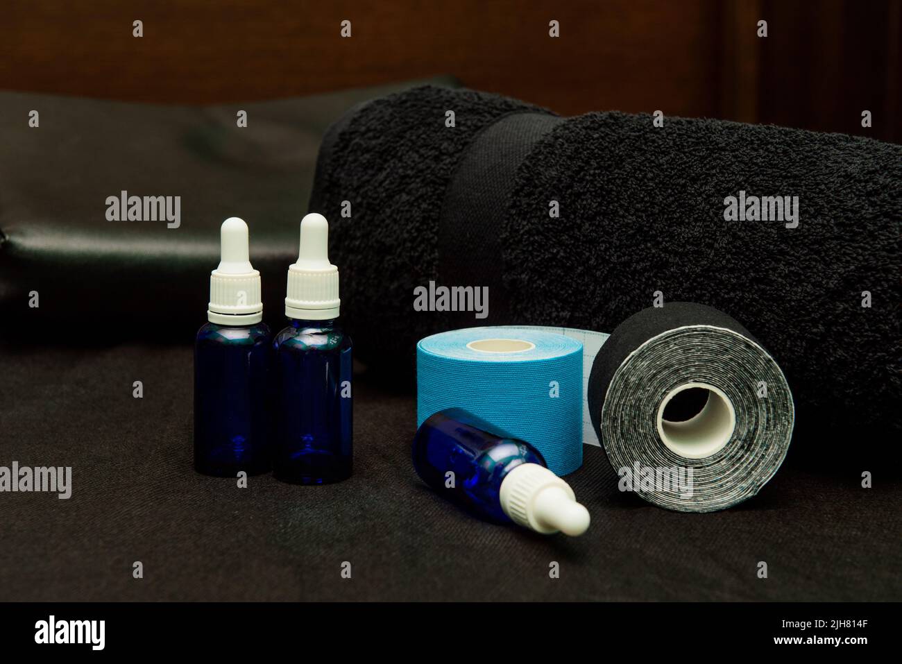 Two-color kinesiology therapy strips and essential oils for massage Stock Photo