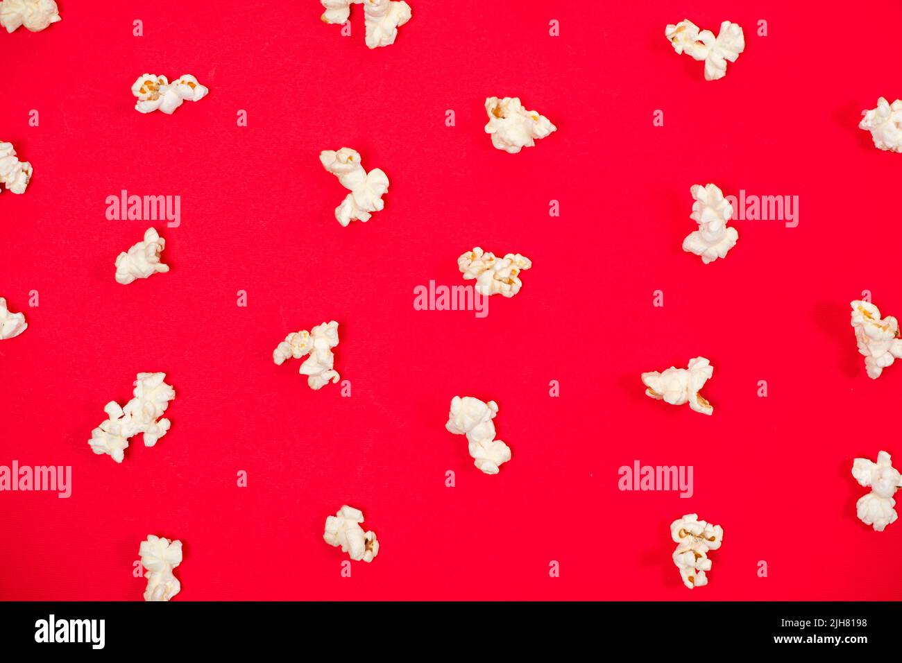 Popcorn on a red background, close-up view from above Stock Photo