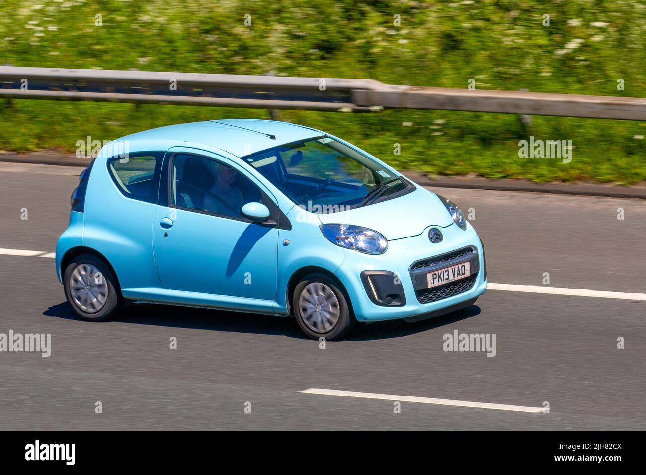 2013 blue Citroen C1 VTR 2dr 998cc petrol 5-speed manual; traveling on the M6 Motorway, Manchester, UK Stock Photo