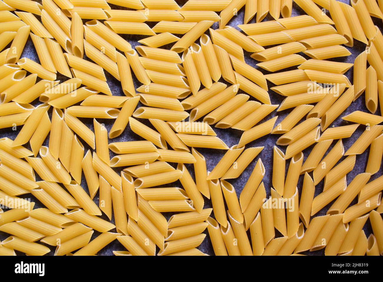 Whole dried Penne rigate pasta Stock Photo