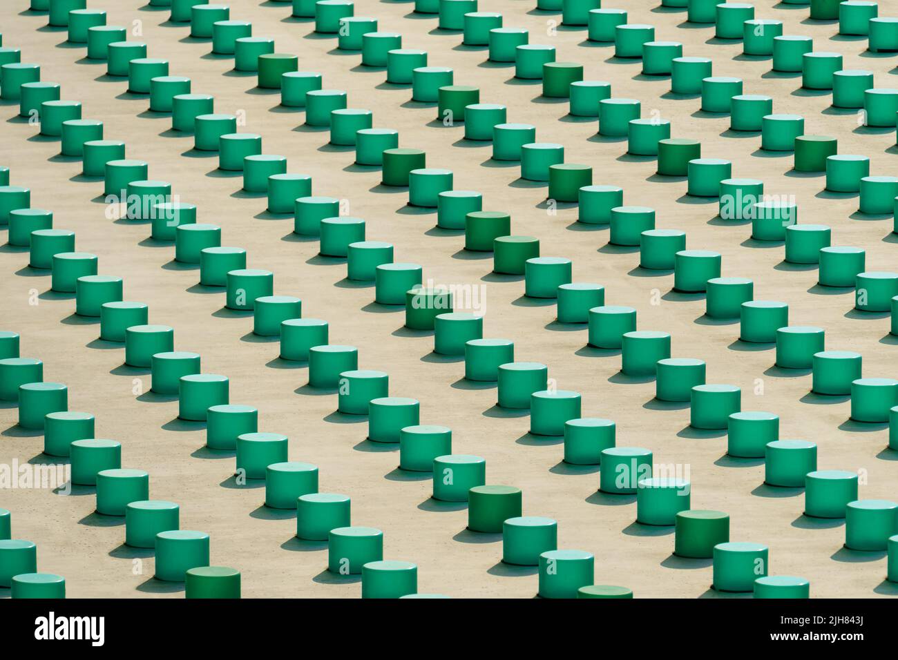 Cropped view of the concrete grey building wall elements with green plastic objects Stock Photo