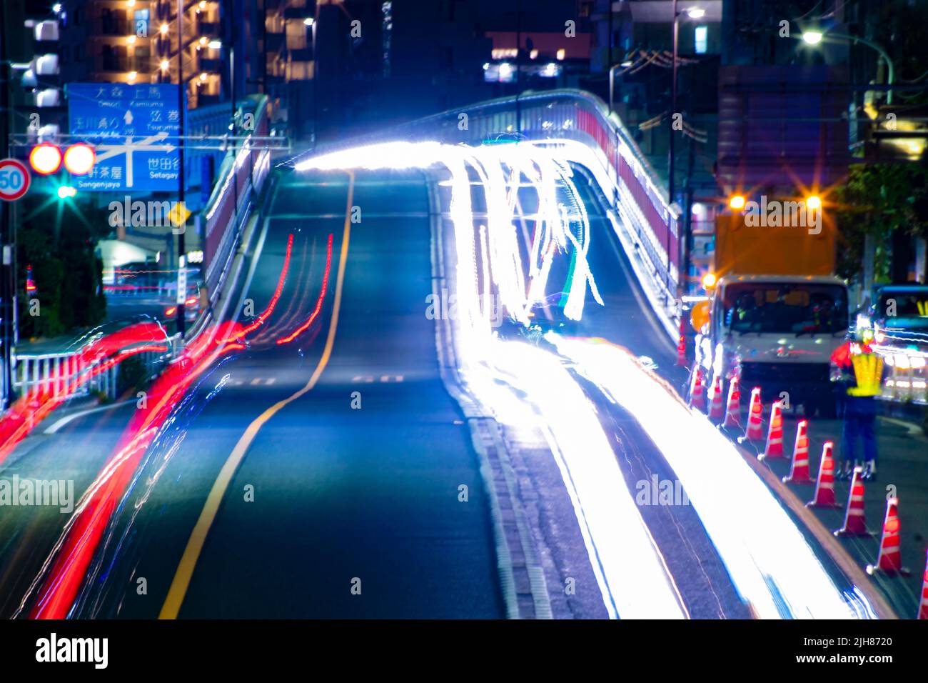 A night traffic jam at the urban street in Tokyo long shot Stock Photo