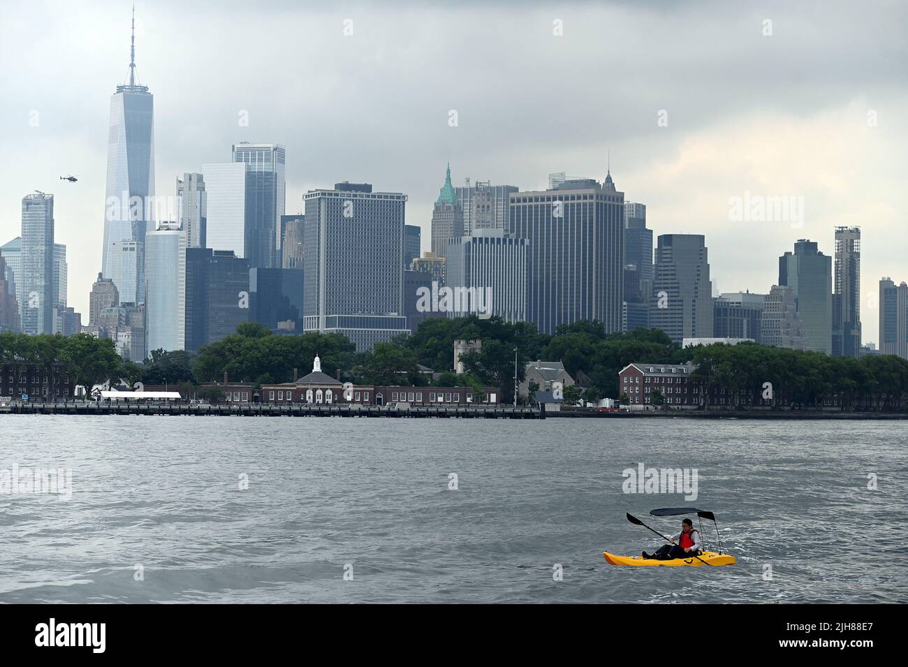 New York, USA. 16th July, 2022. A man on kayak makes his way along the Red Hook neighborhood near 2022 Formula E-Prix New York track, in the Brooklyn borough of New York City, July 15, 2022. (Photo by Anthony Behar/Sipa USA) Credit: Sipa USA/Alamy Live News Stock Photo