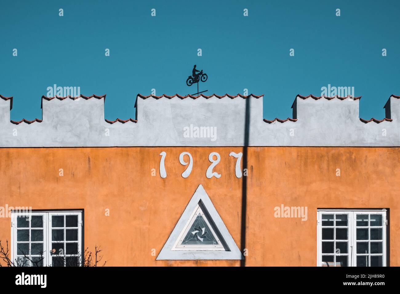 House building from 1927 with a little motorcycle symbol sigh on the roof in Elsinore, Helsingor, Denmark. Stock Photo