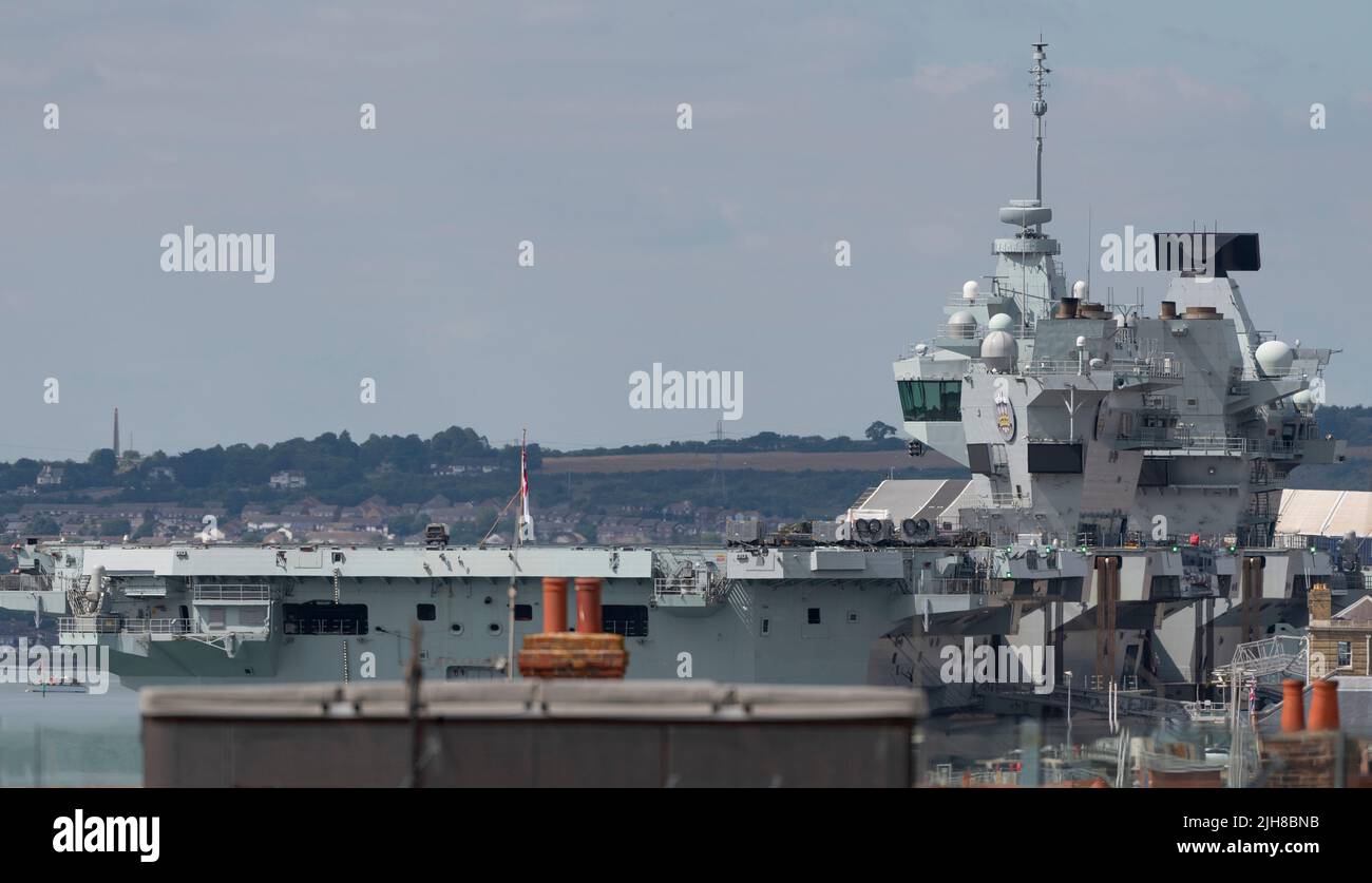 Portsmouth, England, UK. 2022. Viewed across rooftops is the aircraft carrier HMS Prince of Wales alongside in the famous dockyard, UK Stock Photo