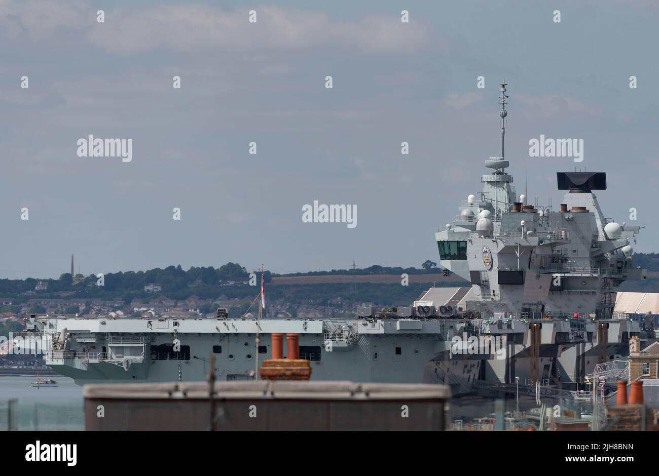 Portsmouth, England, UK. 2022. Viewed across rooftops is the aircraft carrier HMS Prince of Wales alongside in the famous dockyard, UK Stock Photo