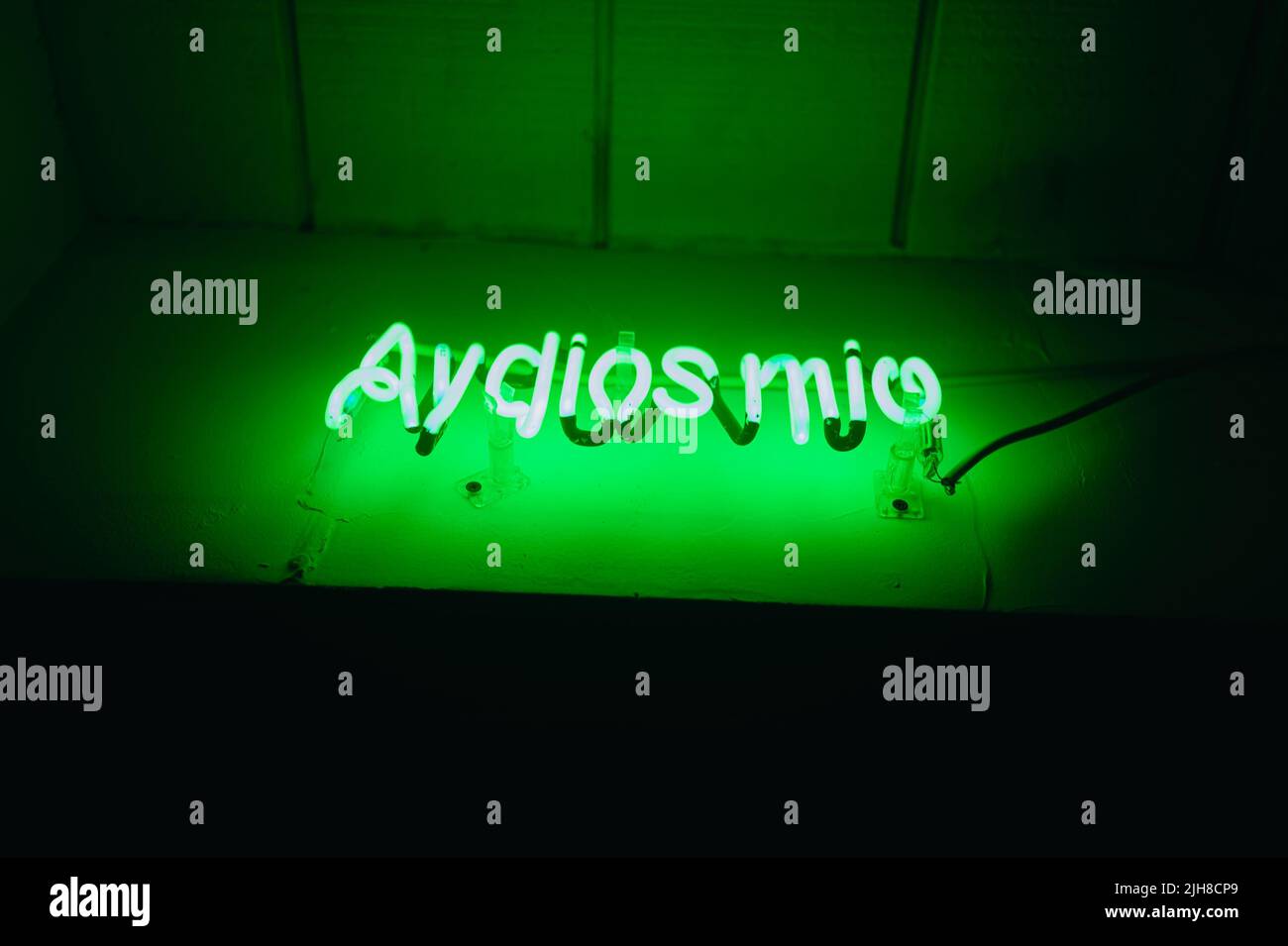 A green neon sign in spanish "Ay dios mio oh my God Stock Photo Alamy