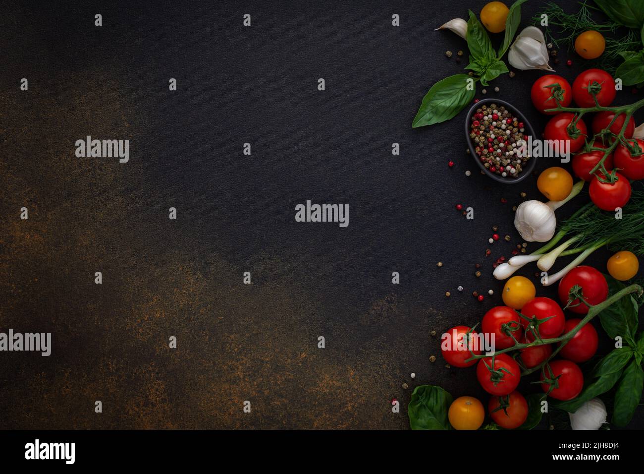 Food background, fresh ripe red and yellow tomatoes, spices and basil ...