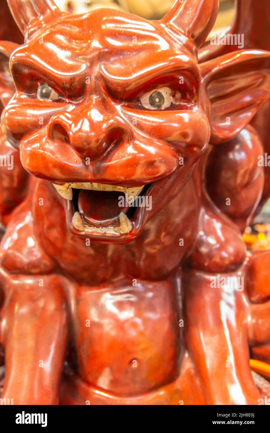 Shiny statue of little red devil Stock Photo Alamy