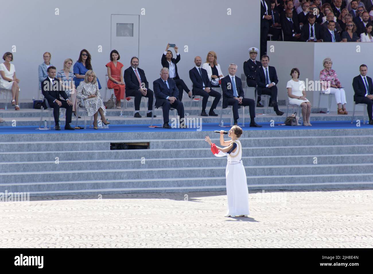 Paris, France. 14th July, 2022. Candice Parise sings France in front of the presidential platform accompanied by musicians from the Paris Fire Brigade Stock Photo