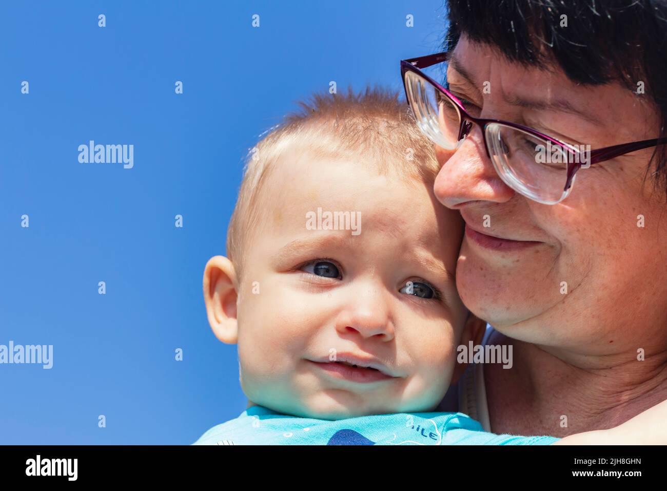 frightened baby in his mother's arms for comfort and safety. Childhood cancer awareness month. Day of charity. Family problem concept.selective focus Stock Photo