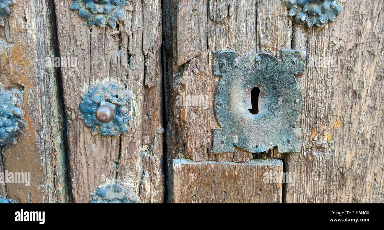 An old and rusty medieval lock on old studded wooden door Stock Photo ...