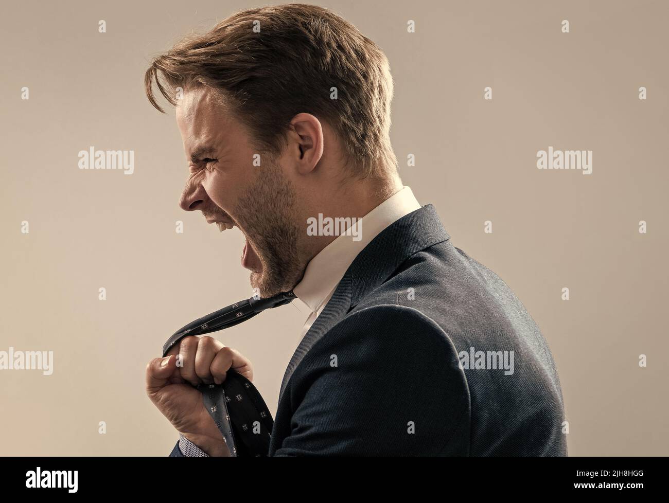 Fight at work. Lawyer scream being pulled by necktie. Physical fight. Angry man screaming Stock Photo