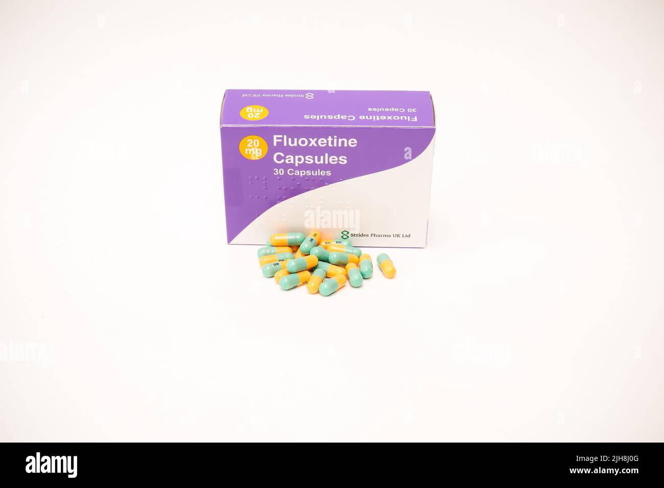 A Fluoxetine Capsules Box with weekly 21 of 20mg capsules isolated on a white background Stock Photo