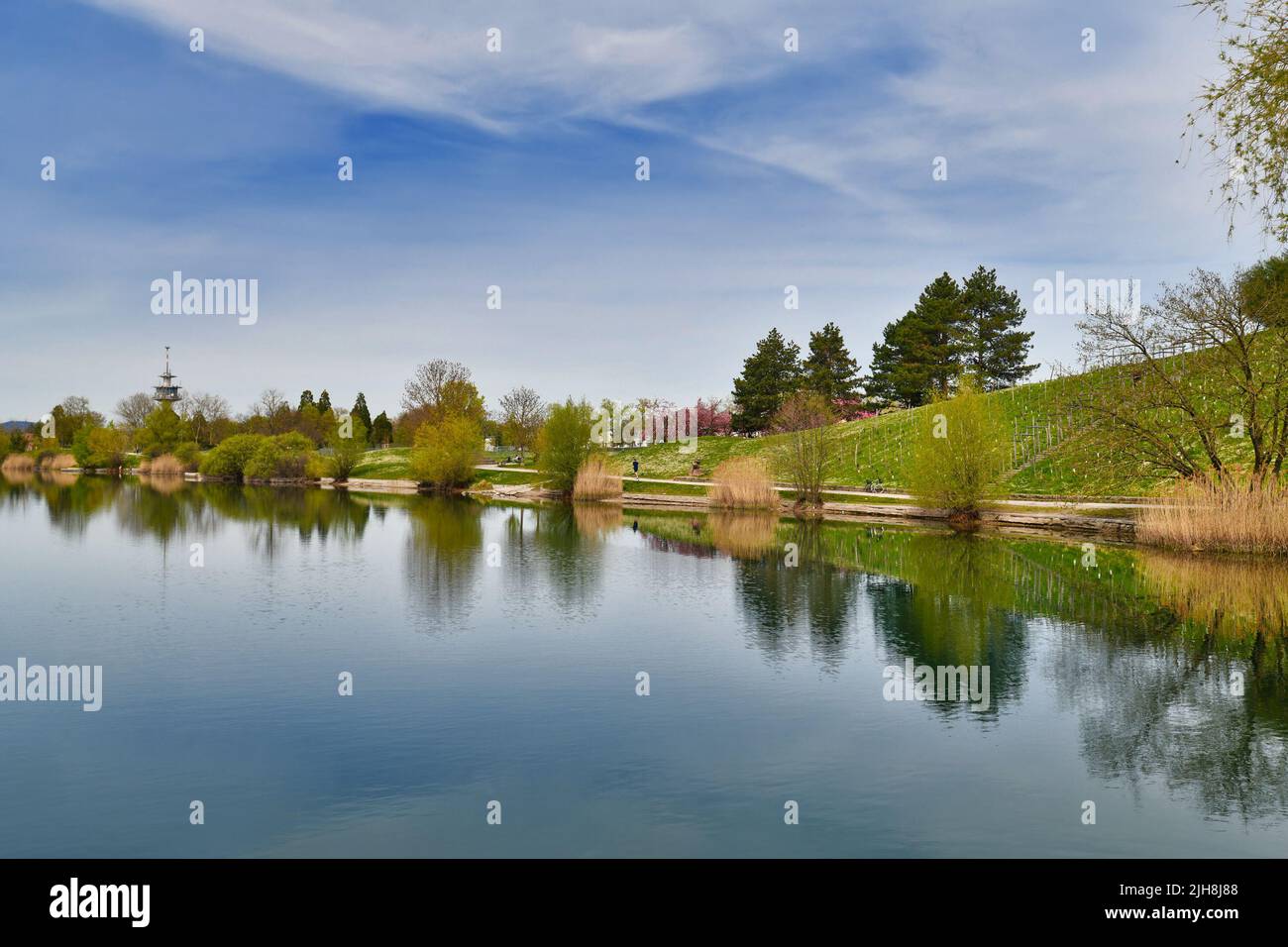 Freiburg, Germany - April 2022: Lake in public park called 'Seepark' on sunny spring day Stock Photo