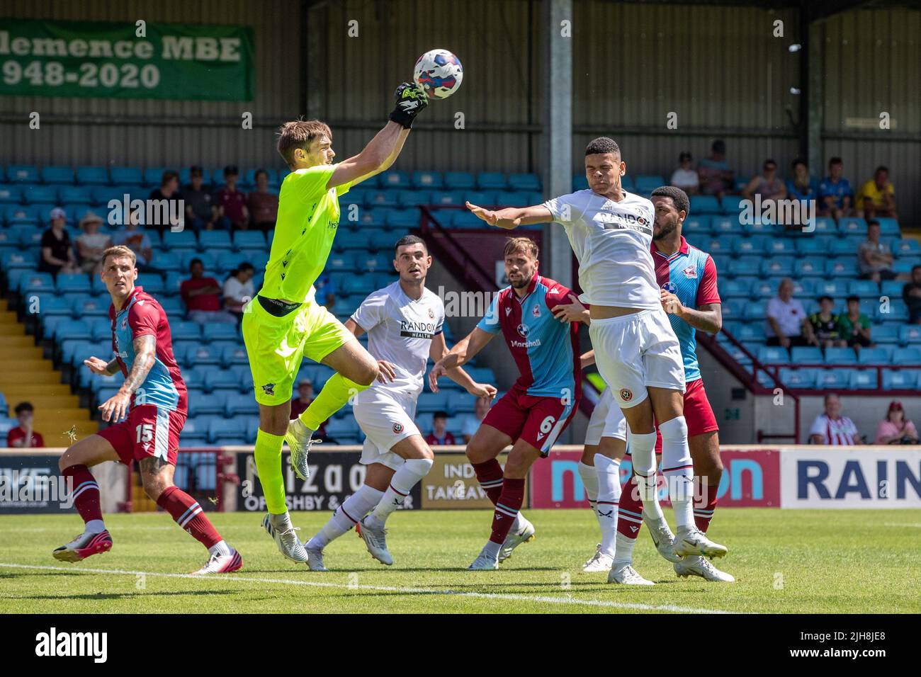 Scunthorpe, UK. 16th July, 2022. Will Osula of Sheffield United rises for the ball but is beaten by goalkeeper Marcus Dewhurst of Scunthorpe United in Scunthorpe, United Kingdom on 7/16/2022. (Photo by James Heaton/News Images/Sipa USA) Credit: Sipa USA/Alamy Live News Stock Photo