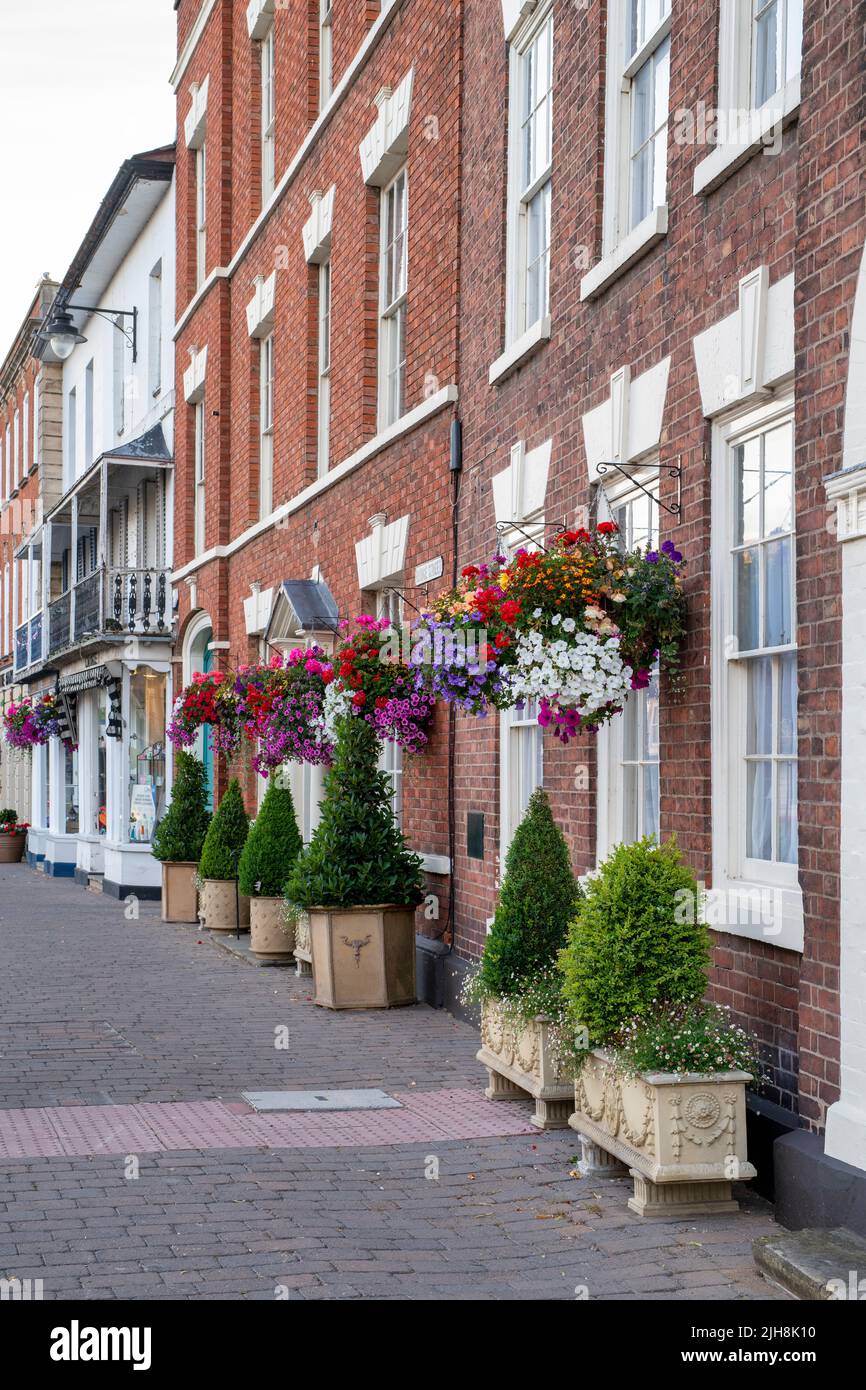 Hanging baskets of flowers on house fronts in the town of Pershore, Worcestershire, UK Stock Photo