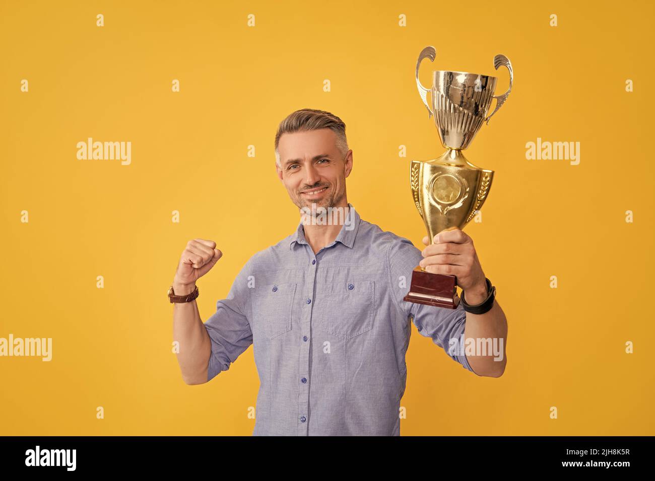 happy successful man hold golden cup, motivation Stock Photo
