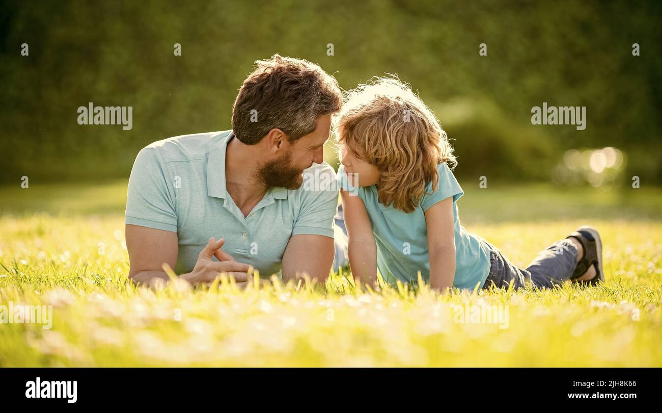 happy family of daddy and son boy relax in summer park green grass, adoption Stock Photo Alamy