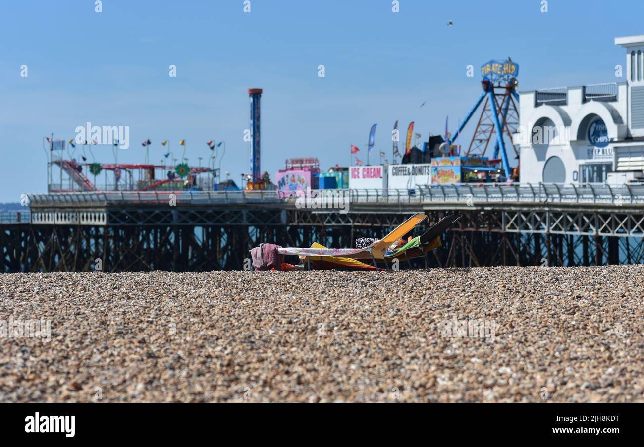 Sun beds on Southsea beach in Portsmouth, England in front of South Parade Pier on a hot summer day Stock Photo