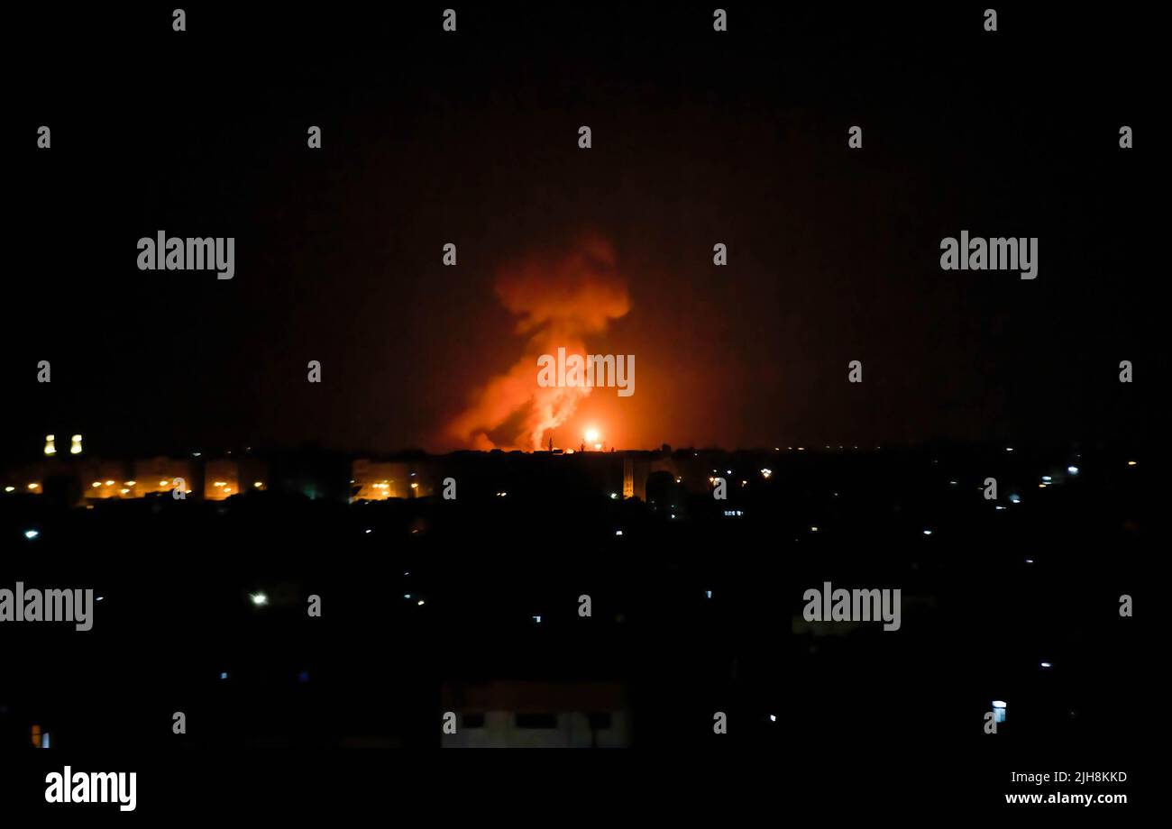 Flames and smoke rise during the Israeli air strikes on Gaza City, in response to the firing of rockets from Gaza towards Israel. Stock Photo