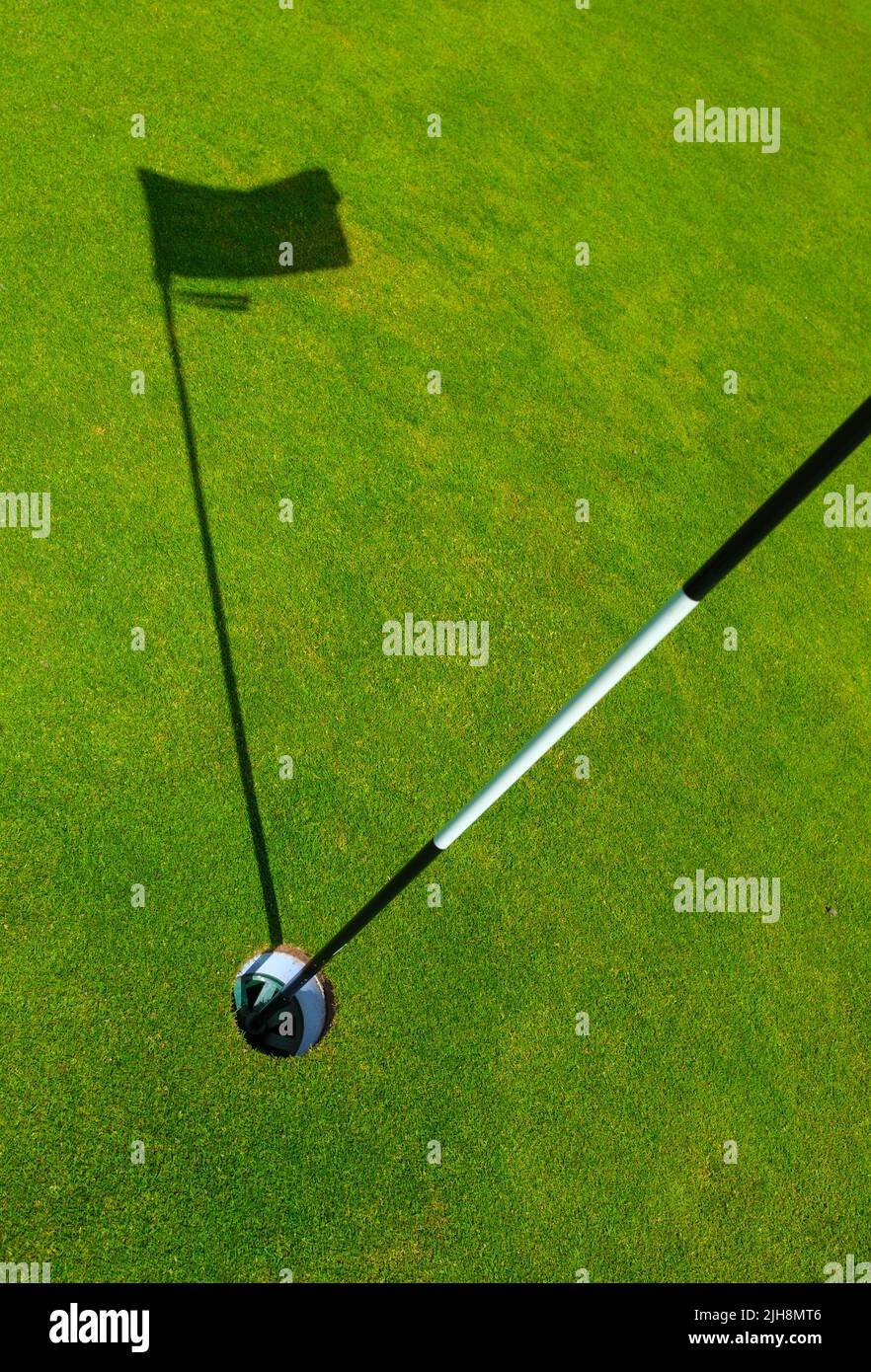 Sports Image Of A Hole On A Golf Course With The Shadow Of The