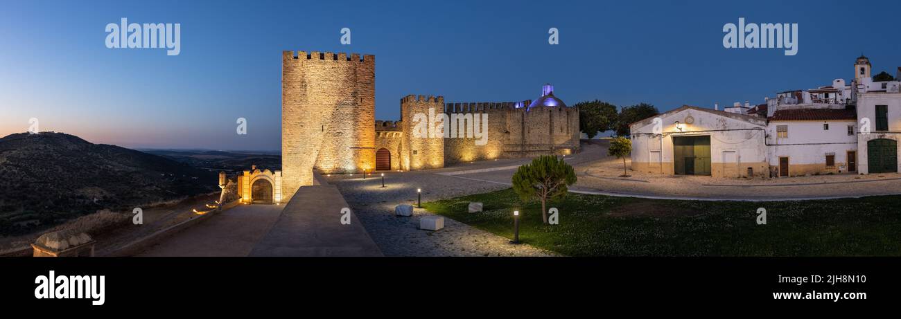 Elvas, Portugal: Castelo of Elvas with the fort 'Forte da Graca' on the hill to the left. Panoramic image from several single images. Blue hour / twil Stock Photo