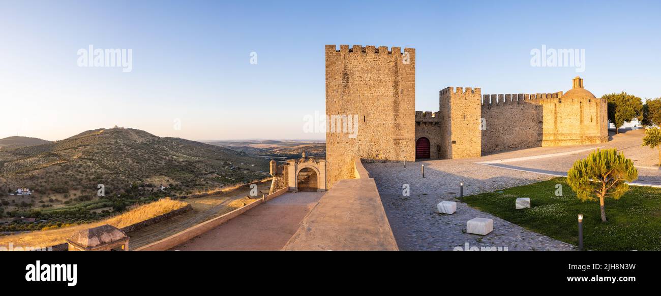 Elvas, Portugal: Castelo of Elvas with the fort 'Forte da Graca' on the hill to the left. Panoramic image from several single images - shot at sunset. Stock Photo
