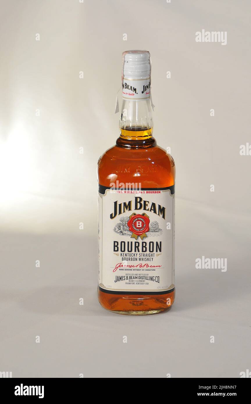 A vertical shot of a bottle of Jim Beam bourbon whiskey in a studio in a  white wall background Stock Photo - Alamy, image size:863x1390