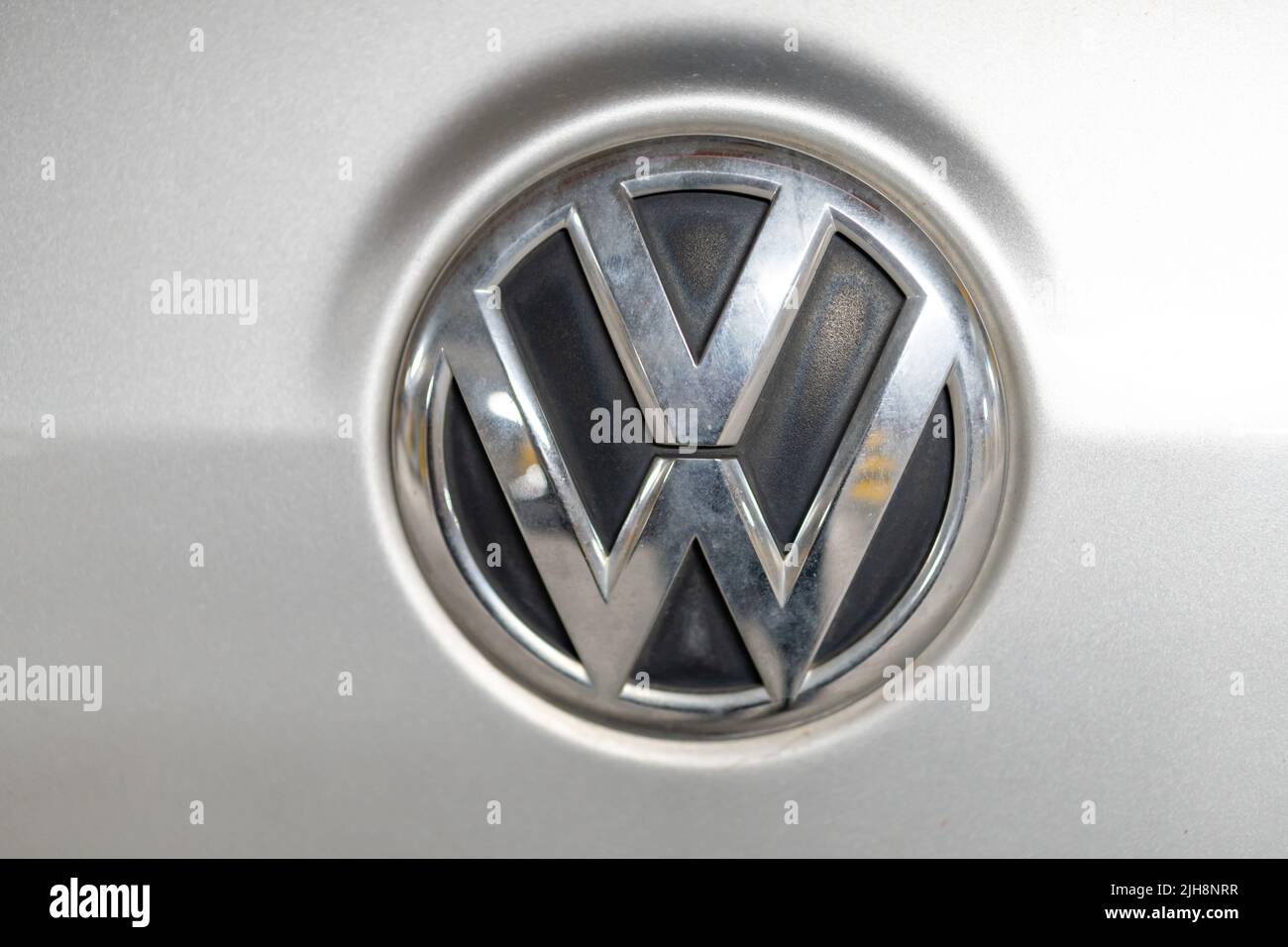 The Volkswagen logo on a silver-colored car in Poznan, Poland Stock Photo
