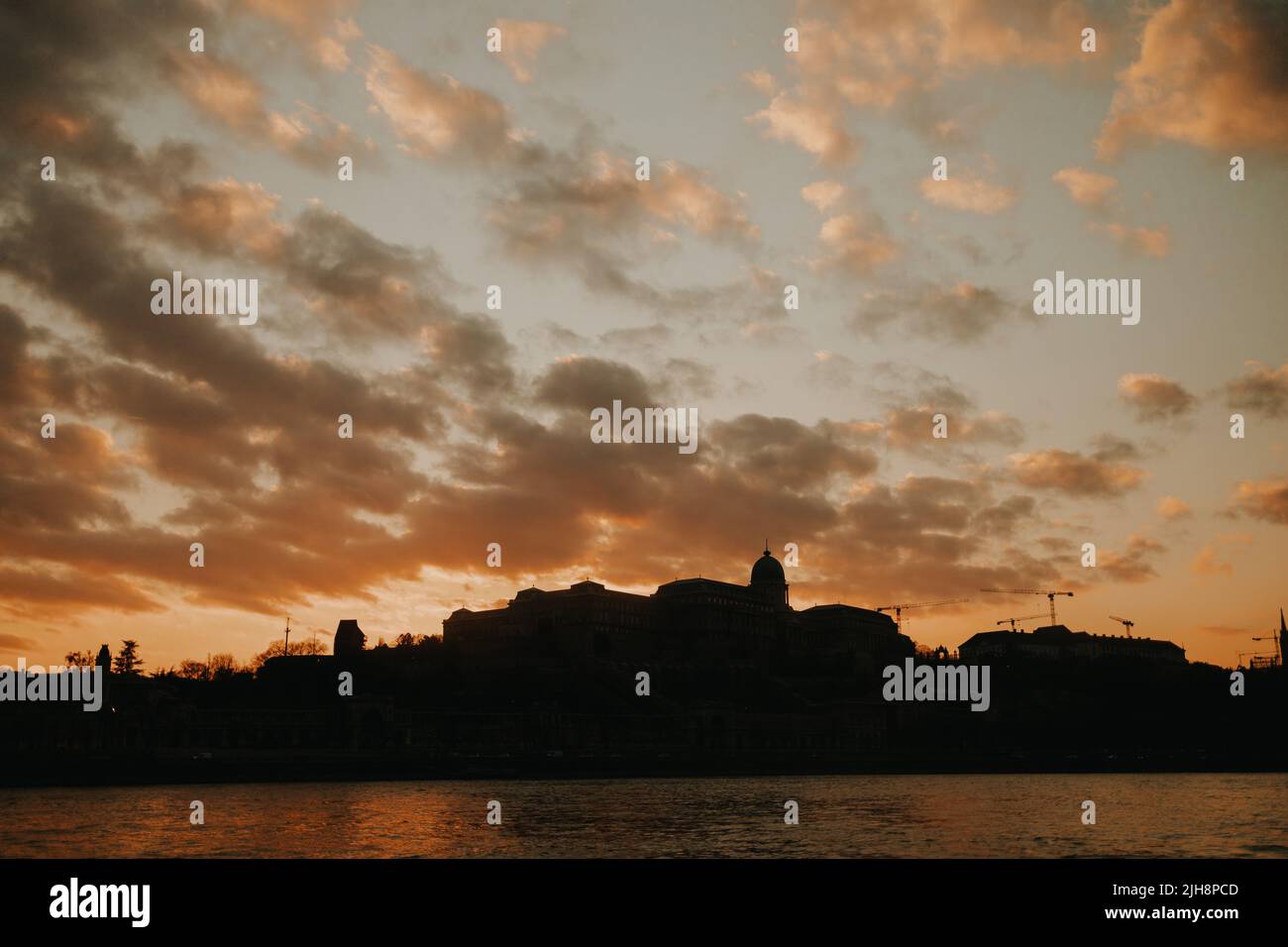 The silhouette of the buildings of Budapest by the sea at sunset Stock Photo