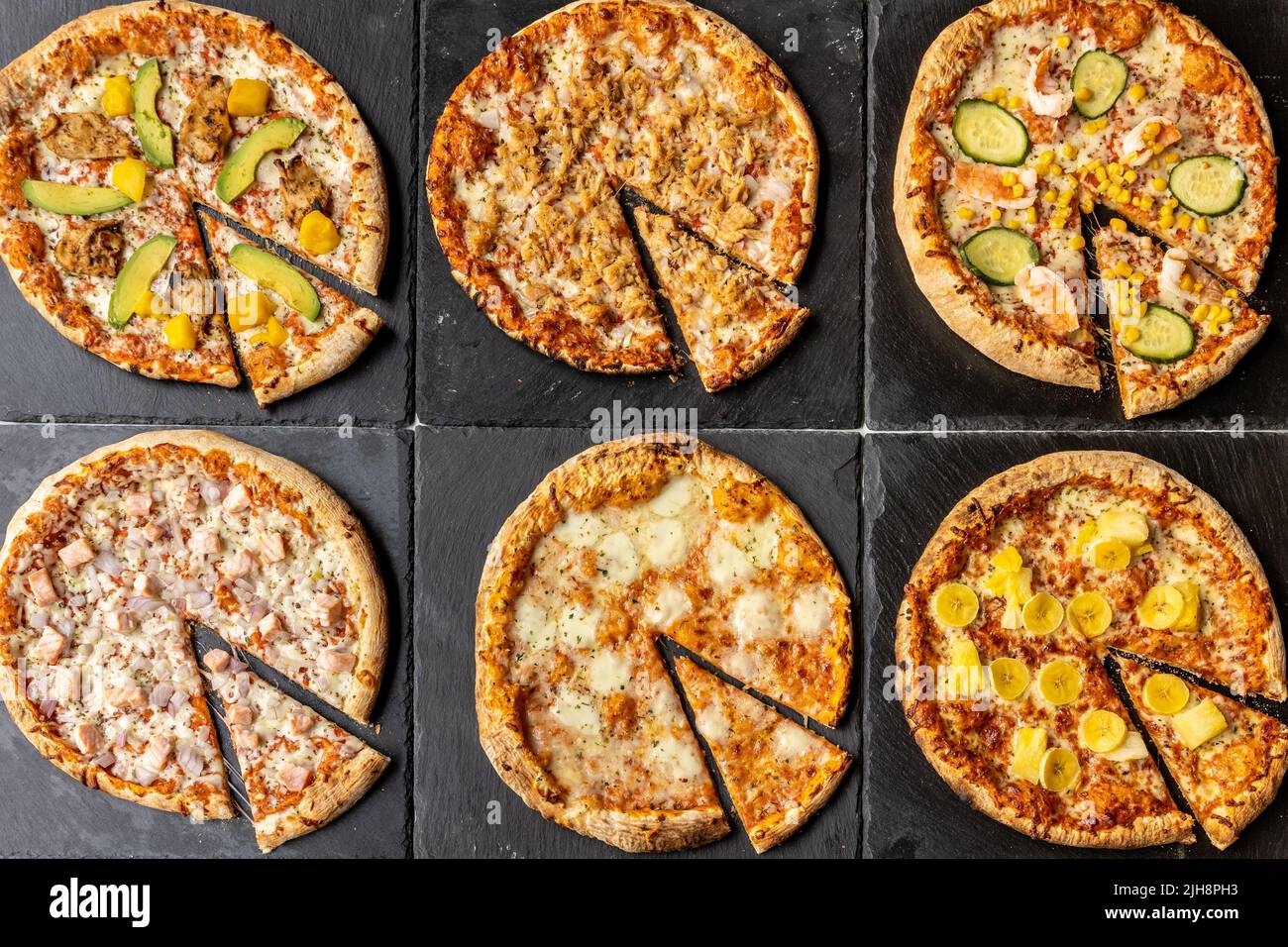 A set of different California-style nontraditional pizzas on black serving plates Stock Photo