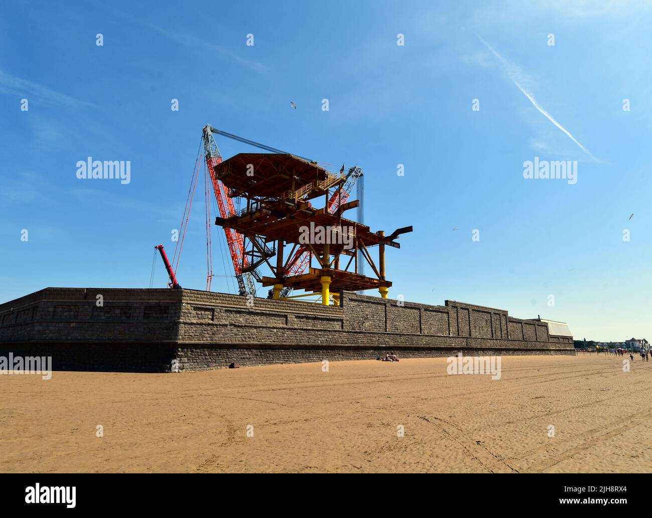 Weston Super Mare, UK. 16th July, 2022. UK Weston Super Mare a decommissioned oil rig is being assembled in the Tropicana on the seafront. This is a World first of its kind being transformed into green art work for tourist and visitor to look around when it soon opens to the public. Picture Credit: Robert Timoney/Alamy Live News Stock Photo