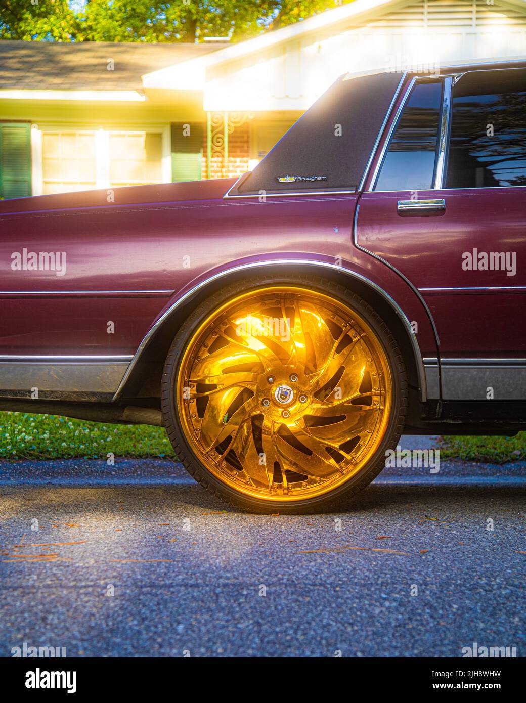 A vertical shot of a vintage red car with a shiny gold wheel Stock ...