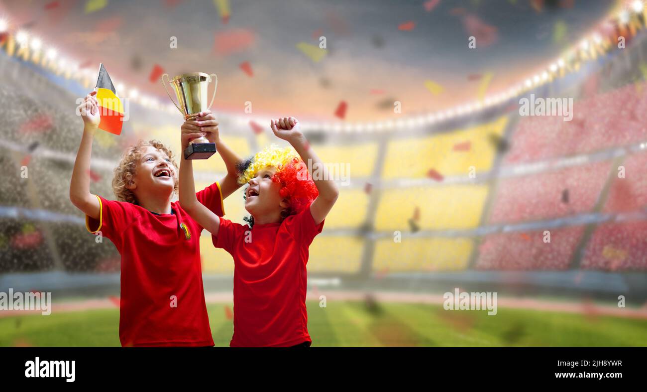 Belgium football fan. Belgian kids play soccer on outdoor field. Cheering team fans celebrate victory. Go Red Devils! Stock Photo