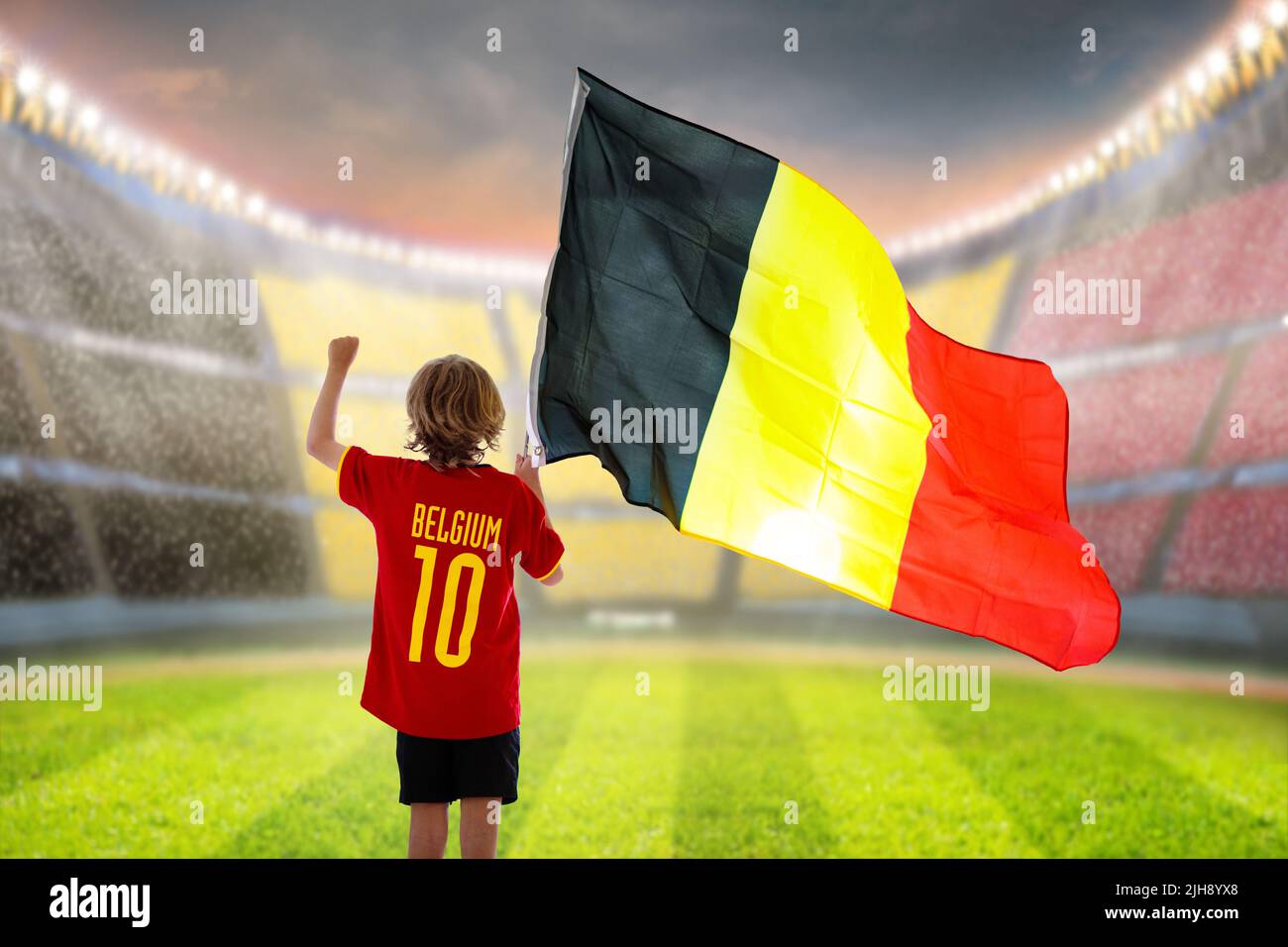 Belgium football fan. Belgian kids play soccer on outdoor field. Cheering team fans celebrate victory. Go Red Devils! Stock Photo