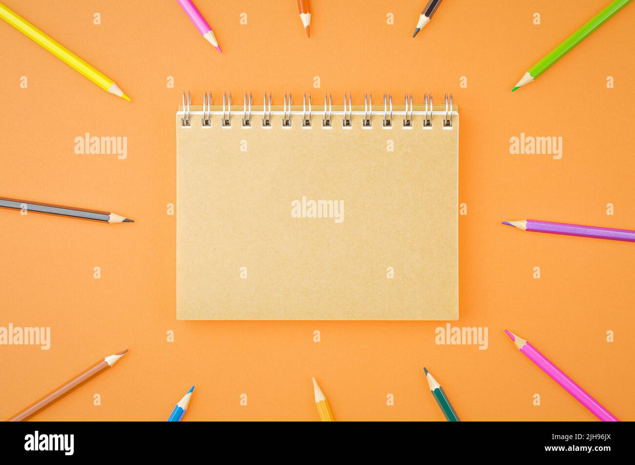 Spiral notepad with colored pencils. Stock Photo