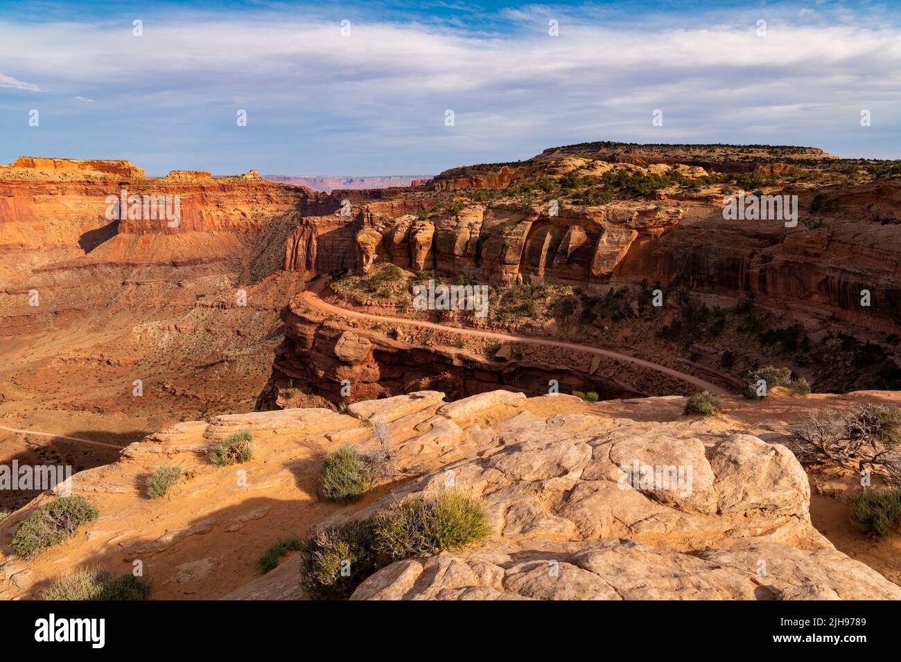 The 4WD Shafer Trail in curves high above Shafer Canyon through a rugged desert landscape in Canyonlands National Park, Utah Stock Photo